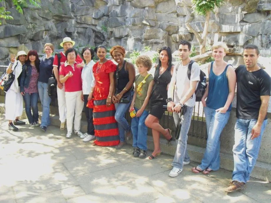 Participants standing together in front of a rock face during a group outing