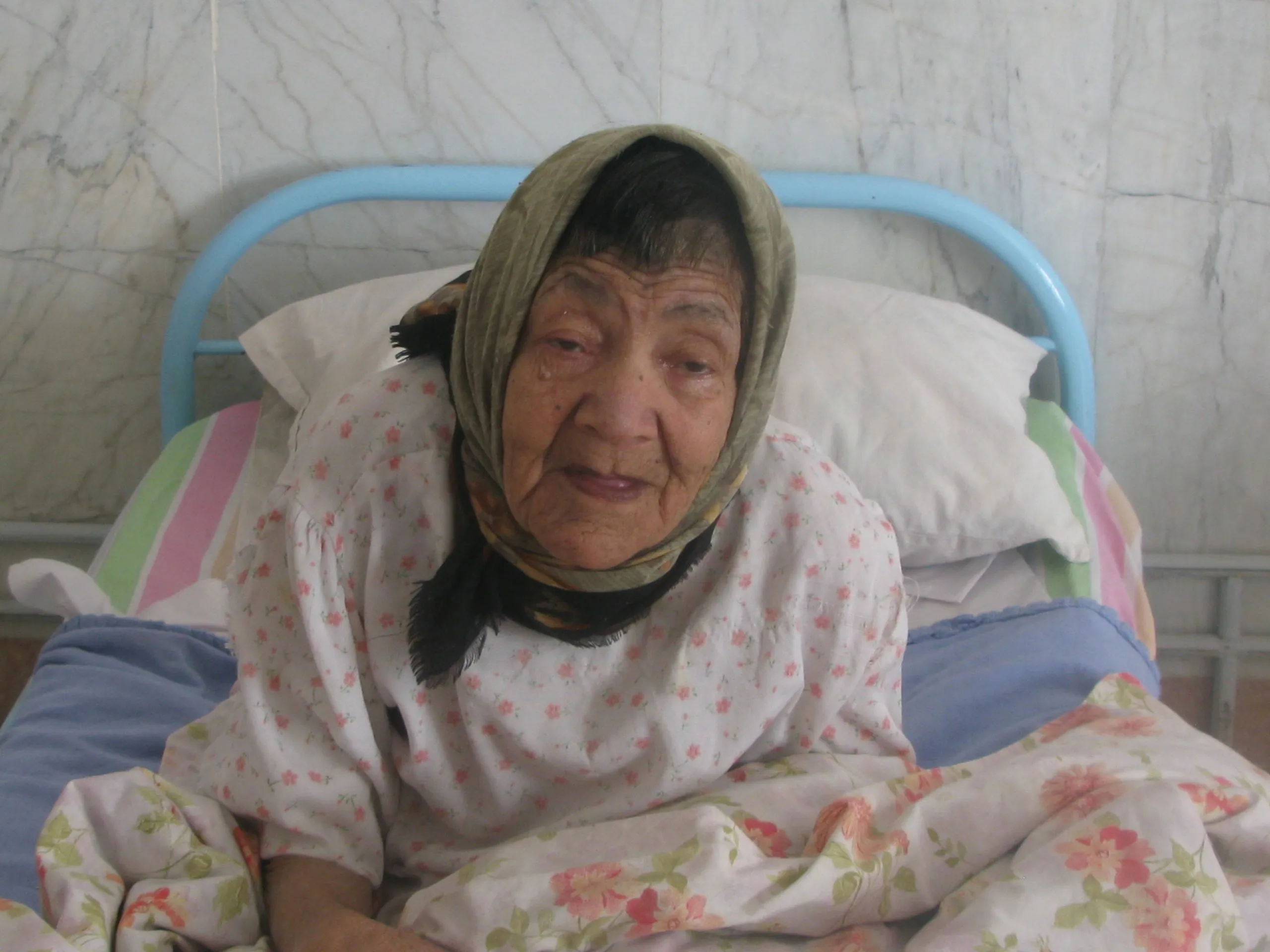 An old woman on her bed