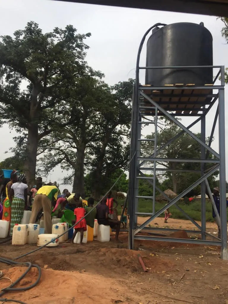 Water tank and people collecting water