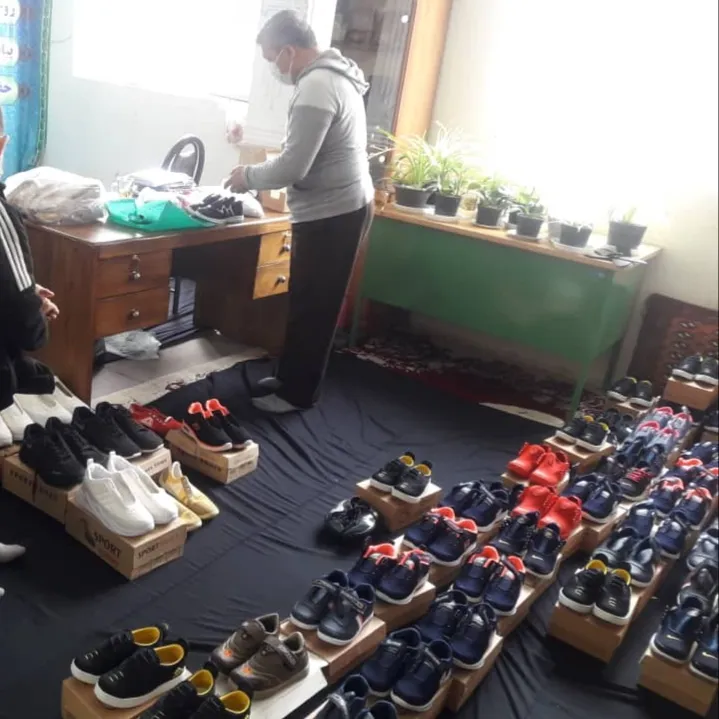 Rows of new children's shoes laid out on their boxes, ready to be handed out