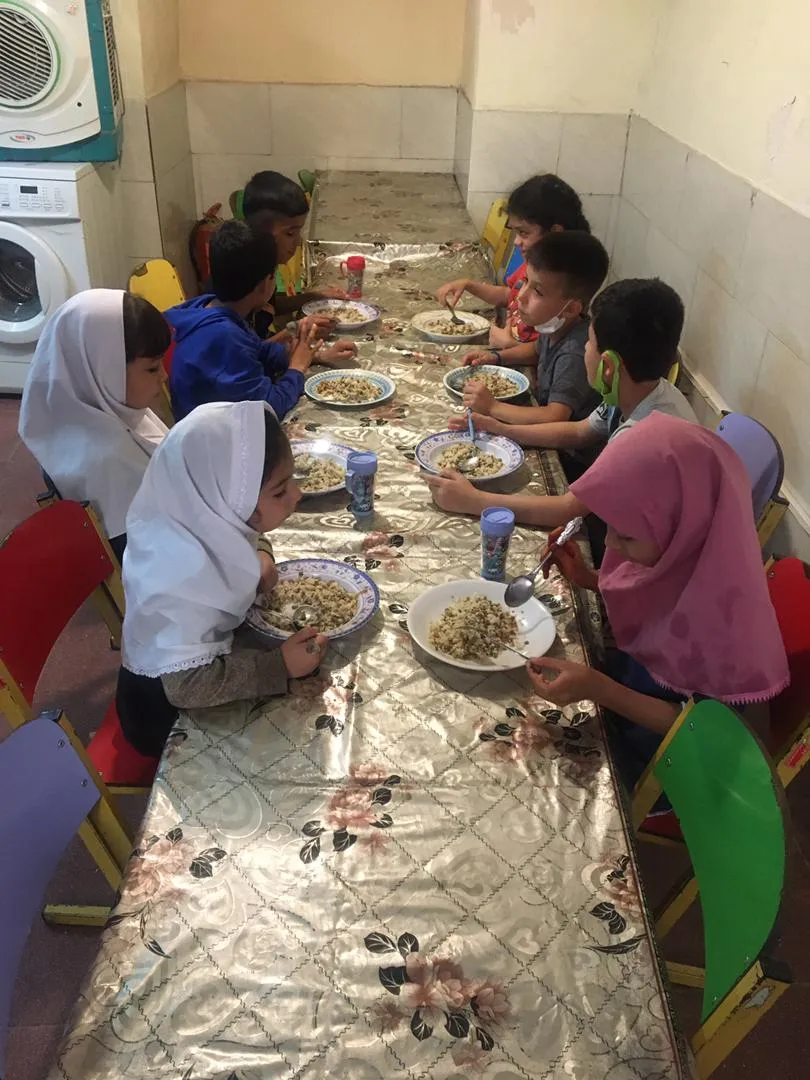 School kids sitting around a table for a meal