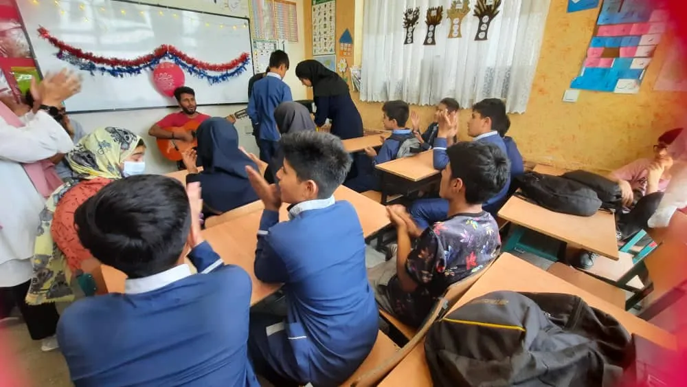 Older kids in a classroom listening to music