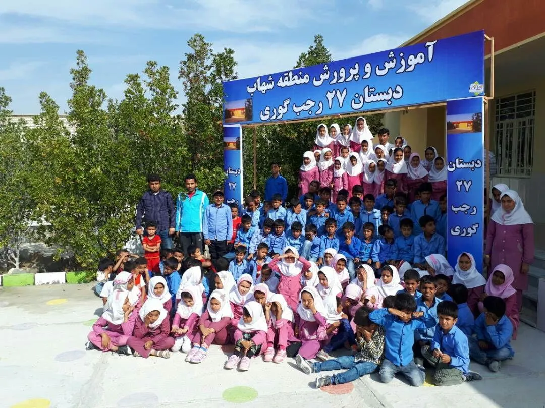 The whole school assembled under the banner at the opening of the new Goori school